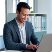 Happy, laptop and typing business man, bank consultant or admin worker smile for research report, project or data. Company computer, administration and professional person working on online account